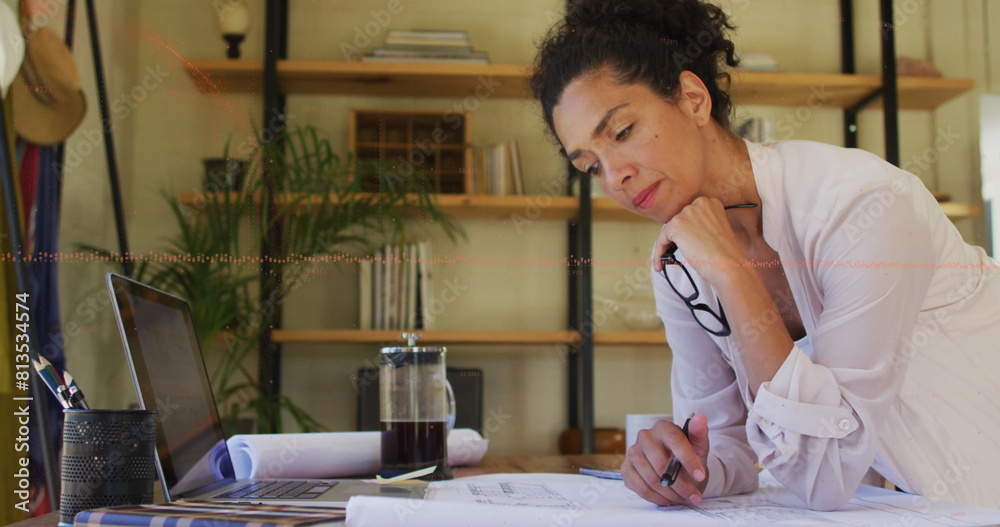 Canvas Prints Image of financial data processing over biracial woman using taking notes