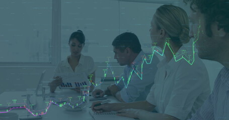 Image of graphs over multiracial coworkers discussing reports in meeting at office