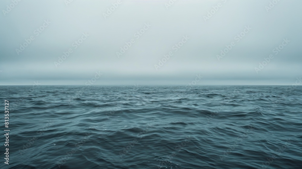 Poster serene view of a large body of water with a clear blue sky in the background. suitable for various o