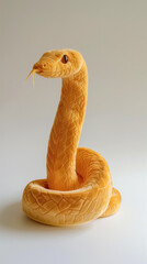 Realistic orange plush snake with detailed scales and alert expression. 