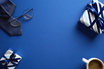 Stylish flat lay of gifts, glasses, and coffee on blue backdrop. Perfect for Father’s Day promotions