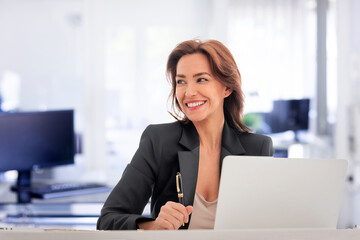 Businesswoman sitting at the office and using laptop for work