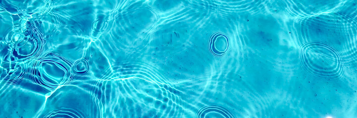Crystal clear turquoise swimming pool water texture, ideal for summer and vacation themes, with a...