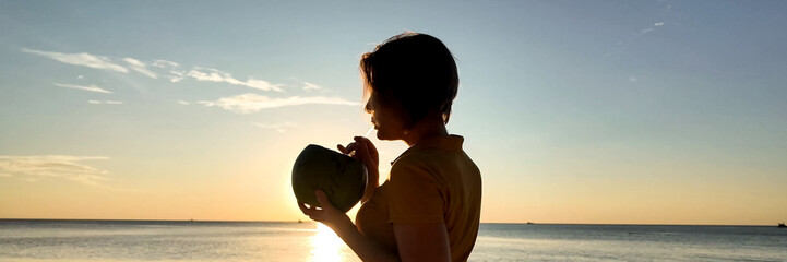 Silhouetted individual enjoying a serene seaside sunset, evoking tranquility and the concept of...