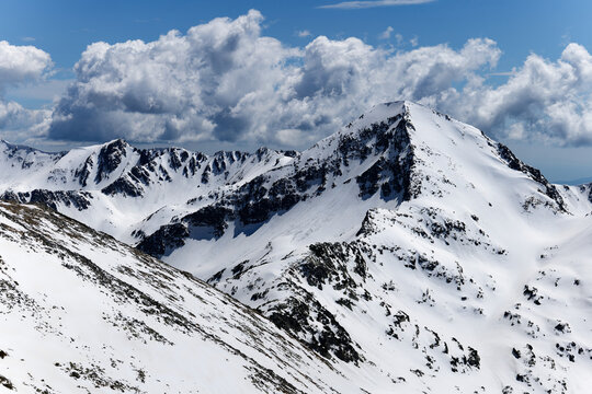 Aerial view of different mountain peaks in the Pirin National Park, Bulgaria. Snow in the mountains. Natural Unesco World Heritage Site. Famous place for hiking and mountaineering. 