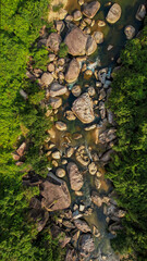 Aerial view of a serene rocky riverbed amidst lush greenery, perfect for themes of nature conservation, Earth Day, and tranquil outdoor landscapes