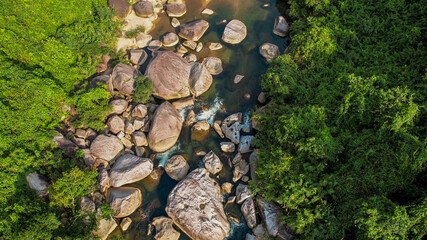 Aerial view of a serene rocky riverbed amidst lush greenery, perfect for themes of nature...