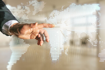 Man hand clicks on abstract creative digital world map on blurred office background, globalization...