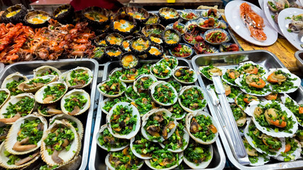 Assorted fresh seafood platters with herbs ready for a feast, ideal for depicting culinary...