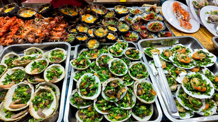Assorted fresh seafood platters with herbs ready for a feast, ideal for depicting culinary diversity or celebrating Seafood Month or regional seafood festivals