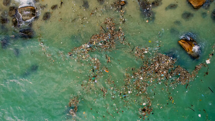 Aerial view of a polluted water body with scattered trash, highlighting environmental issues and...