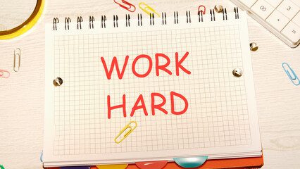 Work Hard written in a checkered notebook