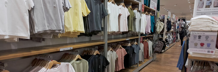 Assorted casual clothing on display in a modern retail store, ideal for shopping concepts and Back to School promotions