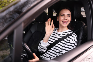 Woman with safety seat belt driving her modern car