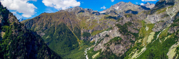 Breathtaking aerial view of a rugged mountain landscape with cascading river, embodying nature's majesty, perfect for Earth Day and environmental conservation themes