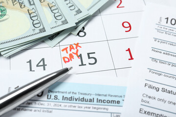 Tax day. Calendar with date reminder, documents, dollar banknotes and pen on table