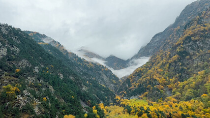 Breathtaking aerial view of a majestic green mountain range with unique rock formations under a clear sky, ideal for nature and travel themes