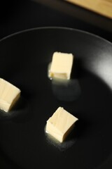 Melting butter in frying pan on table, closeup