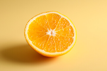 Half of juicy orange on beige background