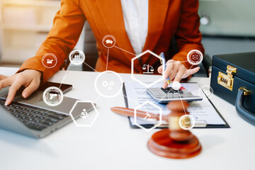 justice and law concept. Male judge in a courtroom the gavel, working with smart phone and laptop and digital tablet compute