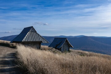 Wooden barn with Bieszczady Mountains in the back captured during daylight © Wirestock