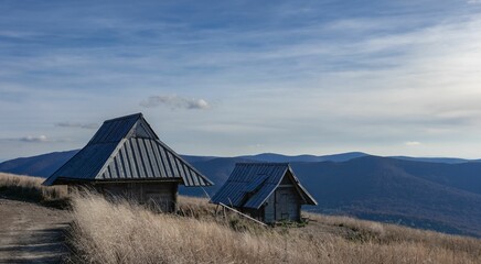 Wooden barn with Bieszczady Mountains in the back captured during daylight