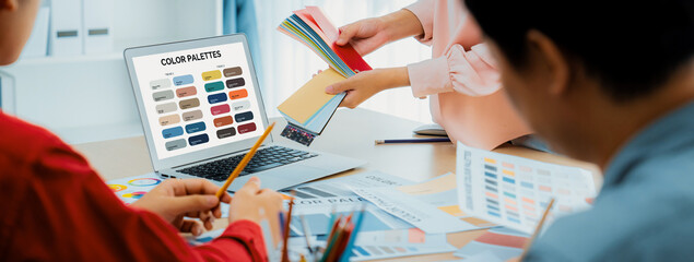 A portrait of creativity graphic designer team select appropriate color for the project by using...