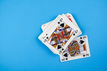 Top view of a pack of playing cards isolated on a blue background