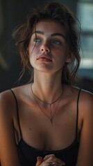 Naklejka premium Thoughtful woman with clasped hands looking away
