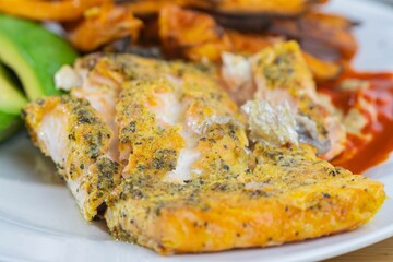 Dish made of chicken tenderloin coated with cheese and spices
