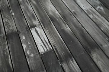 Fototapeta premium Texture of an old, wet wooden dock with white patterns during the daytime