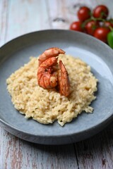 Closeup of risotto with fired shrimp on a blue plate