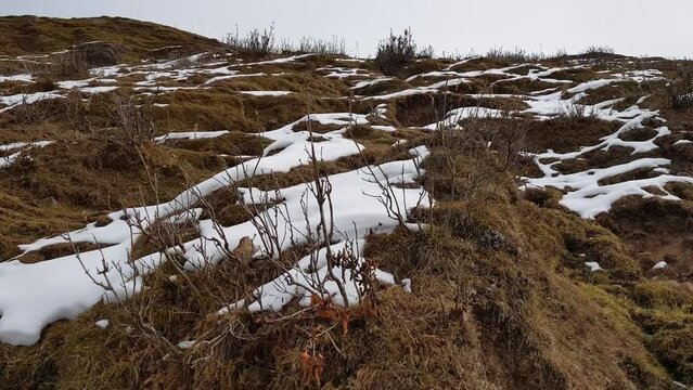 Hilly landscape with snow patches