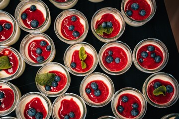 Top closeup of desserts on glass bowls on the dark table