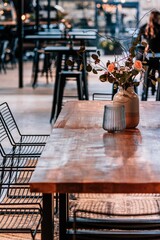 Vertical shot of an empty restaurant table with a flower vase