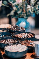 Vertical closeup of sweet toppings on a restaurant table