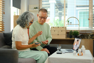 Elderly couple having online medical consultation with general practitioner via laptop. Telehealth...