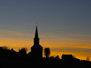 Fototapeta premium Silhouette of a church and trees during a beautiful sunset