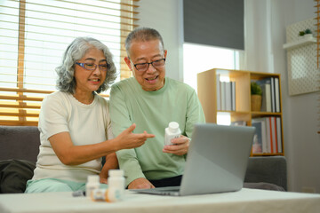 Fototapeta premium Smiling elderly couple in video conferencing with general practitioner on laptop. Telehealth concept