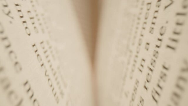 Macro Camera Moving Inside the Books. Close up of English texts on book sheets. Macro shot moves between book pages. 4K