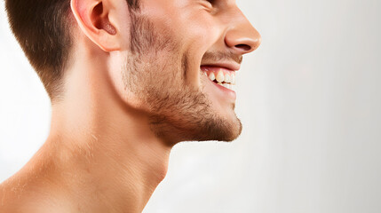Fototapeta premium Close-up of smiling man teeth side shot isolated on white background. Dental advertising