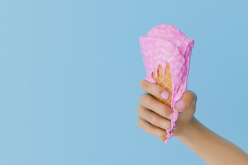 Hand Holding a Melting Pink Ice Cream Cone Against a Blue Background