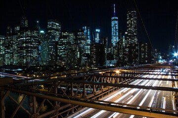 Fototapeta premium Night view from cable-stayed Brooklyn bridge cityscape background, New York