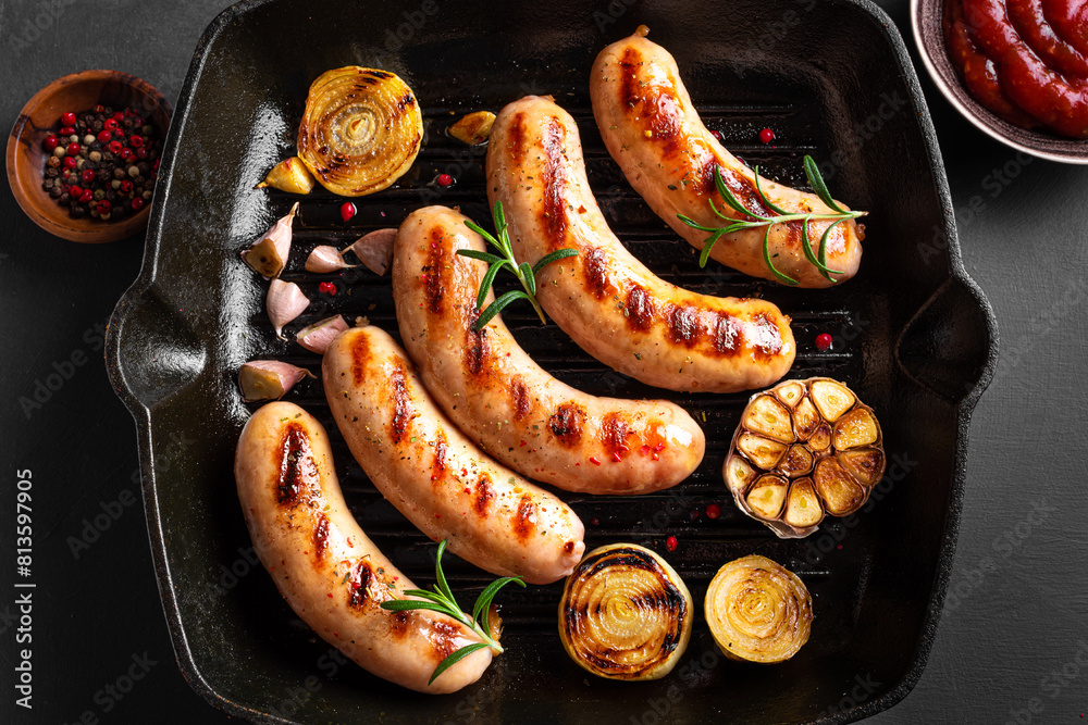 Wall mural grilled sausages on grill pan