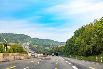 driving along the Highway A7 direction Kirchheimer crossing in hilly landscape with constructiion...