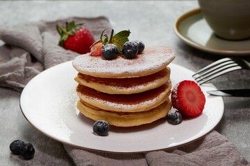Tasty pancake with sugar powder and fresh strawberries slices