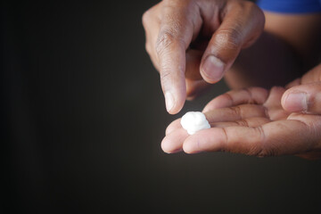 young man applying moisturizing cream 