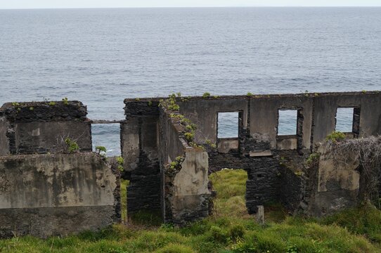 Old abandoned building in Madeira with the calm ocean and the horizon in the background