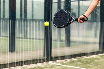 man hand with paddle tennis racket playing