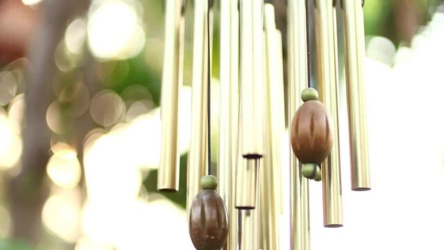 Wind chimes hangs on the house garden.